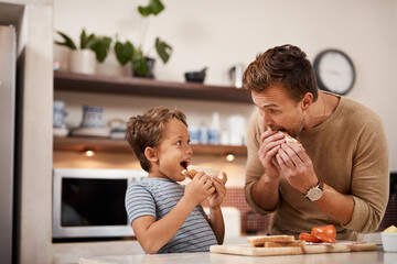 No one makes a better sandwich than dad. a man and his his having a sandwich at home. - obrazy, fototapety, plakaty