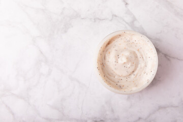 Body cream. Moisturizing and nourishing body cream with shea butter.Natural cosmetics on a marble background.Place for text.