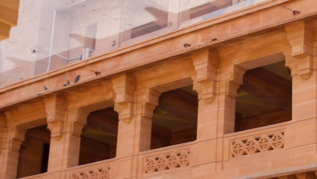 artistic design of palace wall made of red stone at day from flat angle