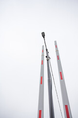 Geometric composition of barriers and LED lamps in the parking lot against the sky. Image for your design or creative illustrations.
