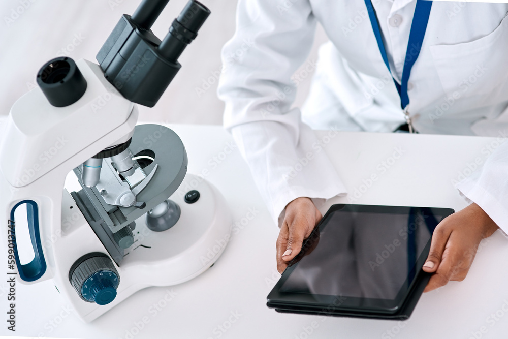 Poster Scientists recommend using a digital tablet when doing your work. High angle shot of an unrecognizable female scientist using a digital tablet while working in a laboratory.