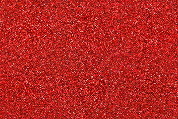 Red color glitter paper texture close up as background