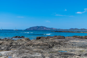 A view past the rocky beach out into the bay at Tamarindo in Costa Rica in the dry season