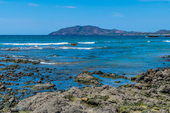 A view from the rocky shoreline out into the bay at Tamarindo in Costa Rica in the dry season