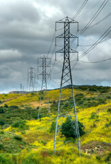 Electrical Towers On Hillside During Storm