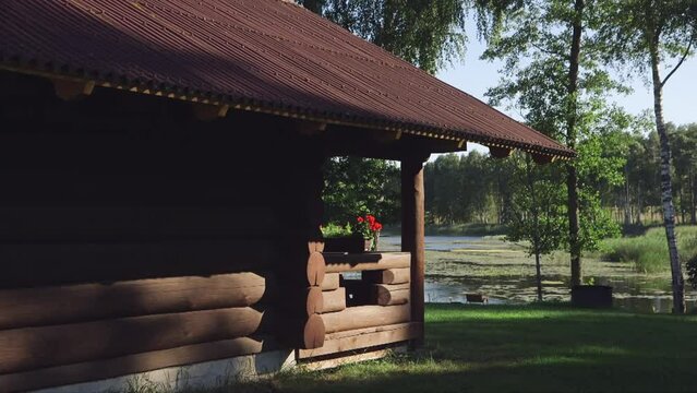 dolly shot of fabulous log camping cabin with a view to the lake