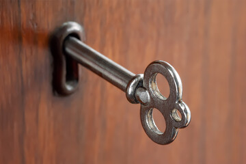 Old key. Old key in the keyhole. Key for the lock. Small depth of field. Selective focus