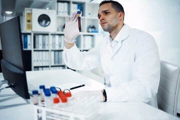 It all begins in the blood. a young scientist conducting medical research on blood in a laboratory.