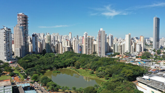 Fantastic aerial view of Vaca Brava Park with tropical nature, a lake and modern residential buildings in the horizon. May 3rd, 2023. Goiania, Goias, Brazil 