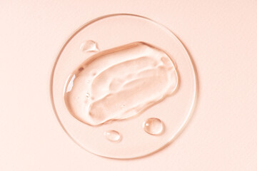 Drops and smears of cosmetics. Drops of liquid transparent gel with bubbles on a brown background.