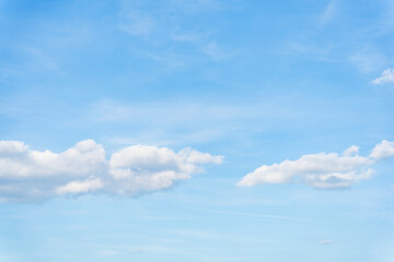 White clouds on a blue sky background.