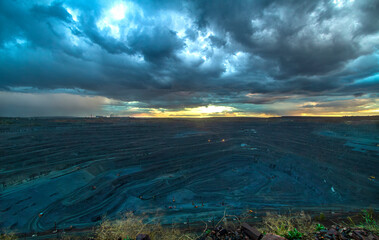 Fototapeta na wymiar Rainy sky over the bowl of an iron ore quarry
