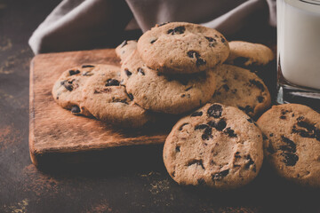 fresh healthy milk and cookies on dark wood background
