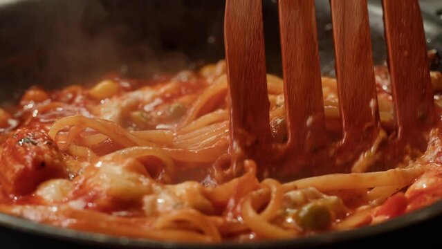Chef cooking tomato Italian bolognese fresh pasta with tomato sause, man making traditional italian dinner on restaurant kitchen, tasty food Generative AI