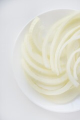 Chopped onion on a white plate. Fresh onion. Vegetables close-up.