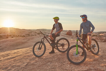 Ready for adventures on the trail. Full length shot of two young male athletes mountain biking in the wilderness.