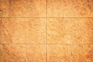 Fototapeta premium Building wall made of ceramic tiles. Beige tiles wall background or texture.