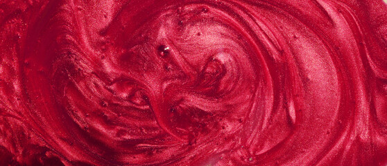 Sample of red glitter gel with small particles, texture of highlighter cosmetics, lipstick, blush