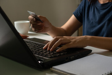 Online shopping concept. Woman holding credit card and typing on laptop for online shopping and payment makes a purchase on the Internet, Online payment, Business financial and technology.