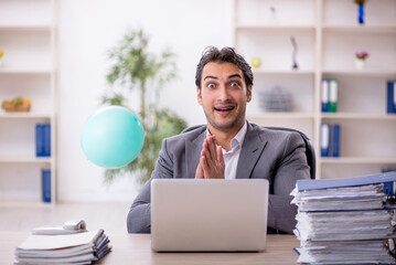 Young male employee and too much work in the office