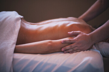 Photographs of massage and bodywork. Male therapist working on female client.  - 599055333