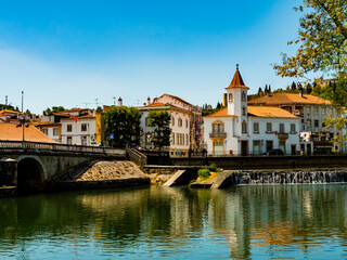 Fototapeta na wymiar Stunning skyline of Tomar reflected in Nabao river, Santarem District, Portugal