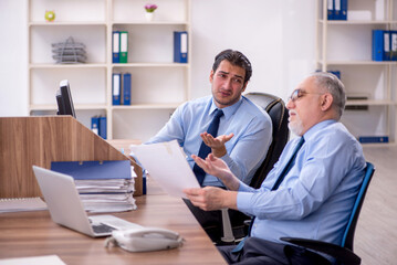 Two male colleagues working in the office