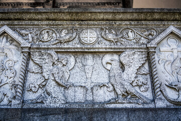 Bas-relief with angel and eagle on a grave in the Monumental Cemetery of Milan, Lombardy region, Italy, where many notable people are buried.