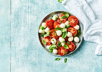 Caprese salad with mozzarella balls and cherry tomato. Top view