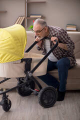 Old man looking after newborn at home