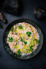 Italian food risotto with parmesan, champignon and greens.