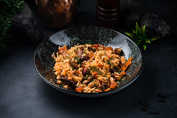 Dinner pilaf with with lamb, raisins, almonds, carrots, tomatoes, onions and herbs.
