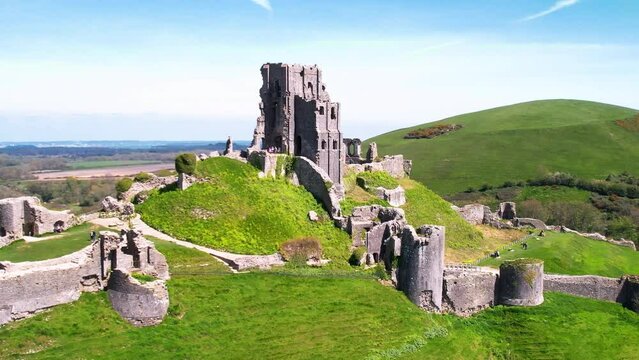 Telephoto aerial shot circling the ruins of Corfe Castle in Dorset