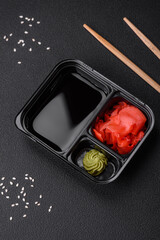 Pickled ginger, soy sauce and wasabi in portioned plastic containers