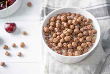 Fresh breakfast with chocolate balls with milk in a bowl