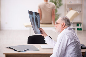 Young male patient visiting old male doctor radiologist