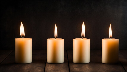 Fototapeta na wymiar Line of four burning candles wooden floor black background