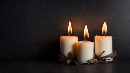 Fototapeta na wymiar Three burning candles black wall background