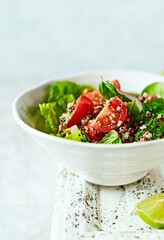 Quinoa salad with cherry tomato, lettuce, spinach and herbs