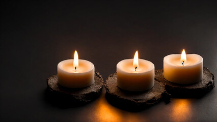 Fototapeta na wymiar Three small burning candles black floor