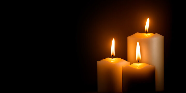 Three white candles black background