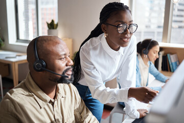 A deeper understanding connects us. a businessman and businesswoman using a headset and computer while working in a modern office.