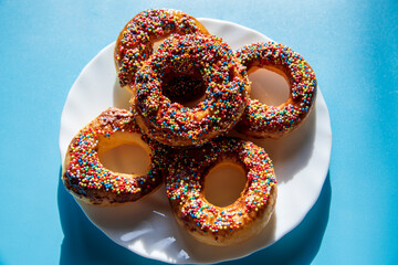 Chocolate sprinkle delicious donuts on a blue background...