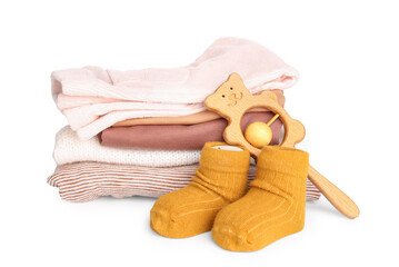 Stack of baby clothes, socks and wooden toy on white background