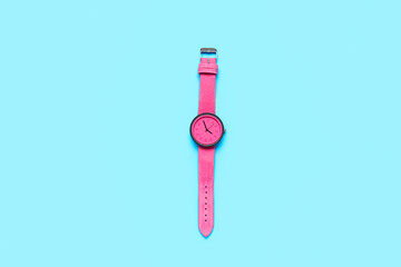 Stylish female wristwatch on color background