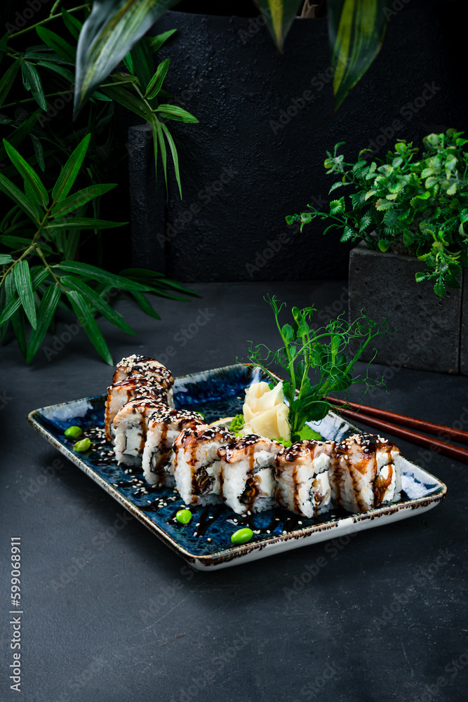 Poster Japanese sushi roll set with eel, Philadelphia cheese, green peas, ginger and wasabi.