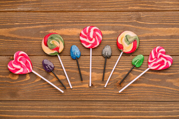 Composition with sweet lollipops on wooden table