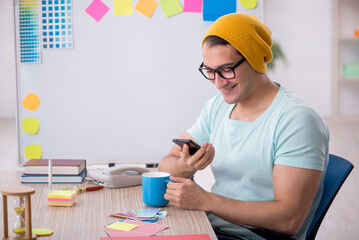 Young male designer sitting in the office