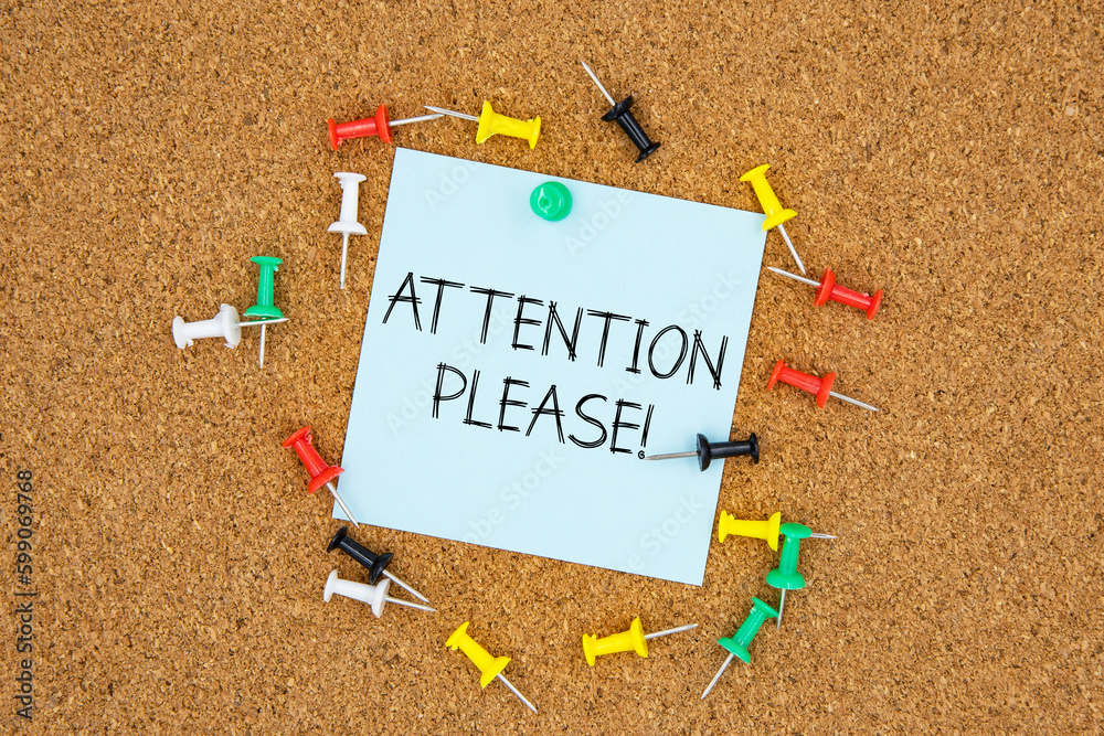 Fototapete attention please text on light blue post-it paper pinned on bulletin cork board surrounding by multi