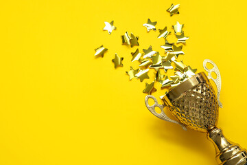 Gold cup with stars on yellow background